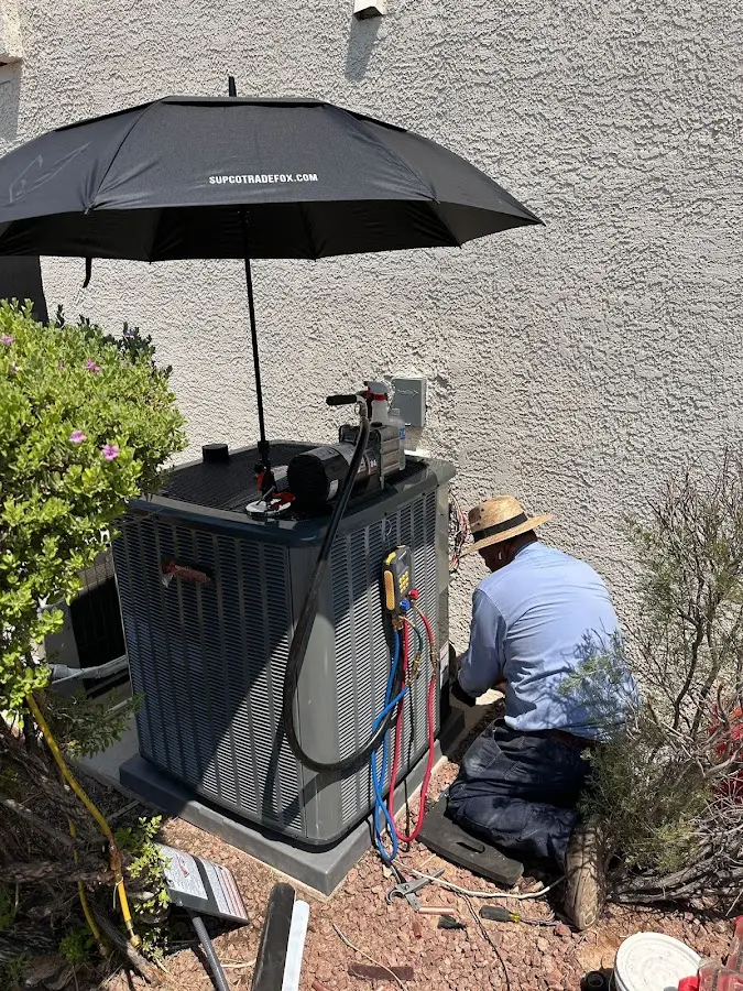 HVAC technician performing outdoor AC maintenance in Union Beach